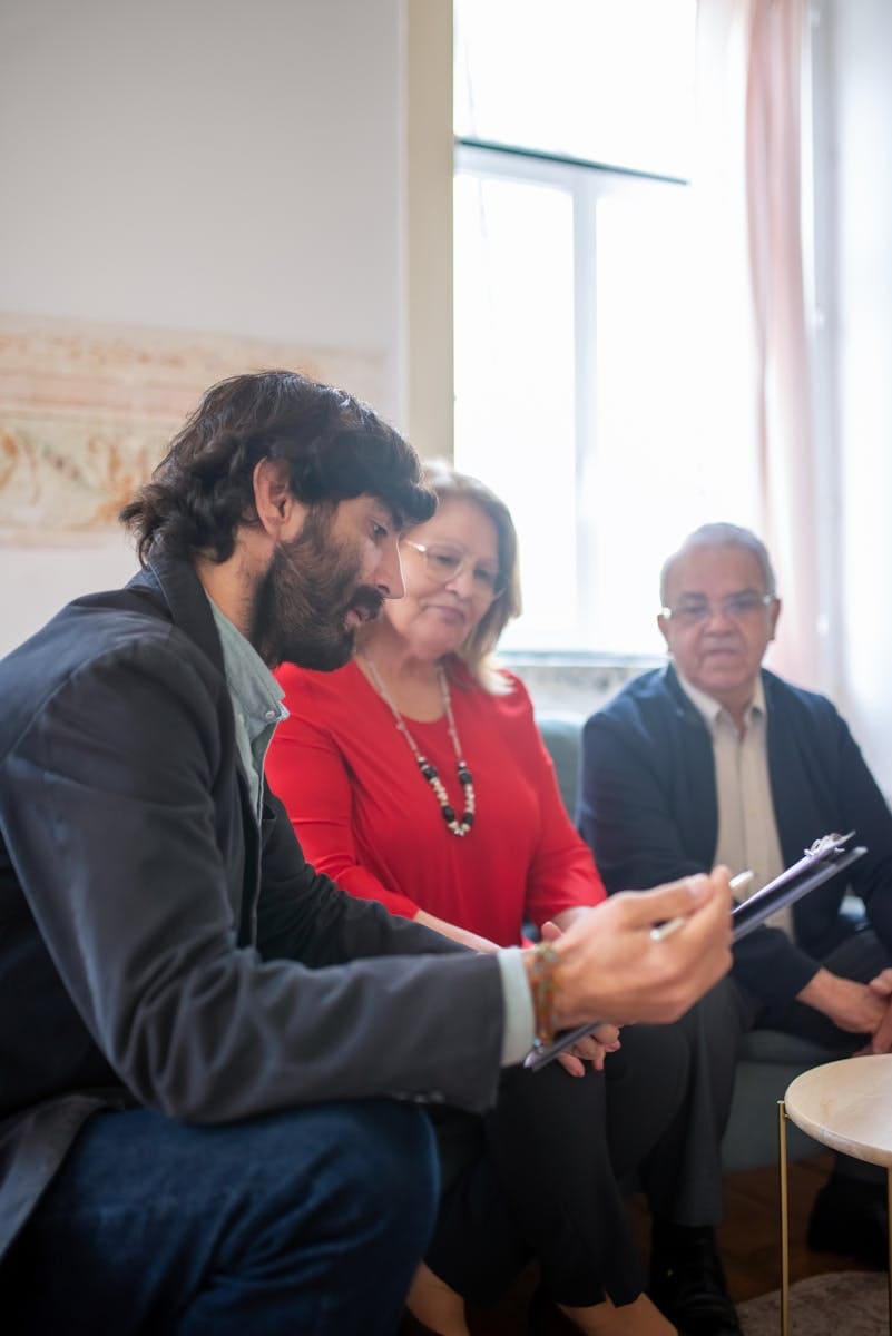 Man Discussing Documents with His Clients